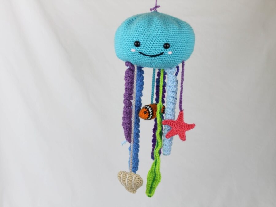 Blue crochet octopus baby mobile with hanging sea-life motifs