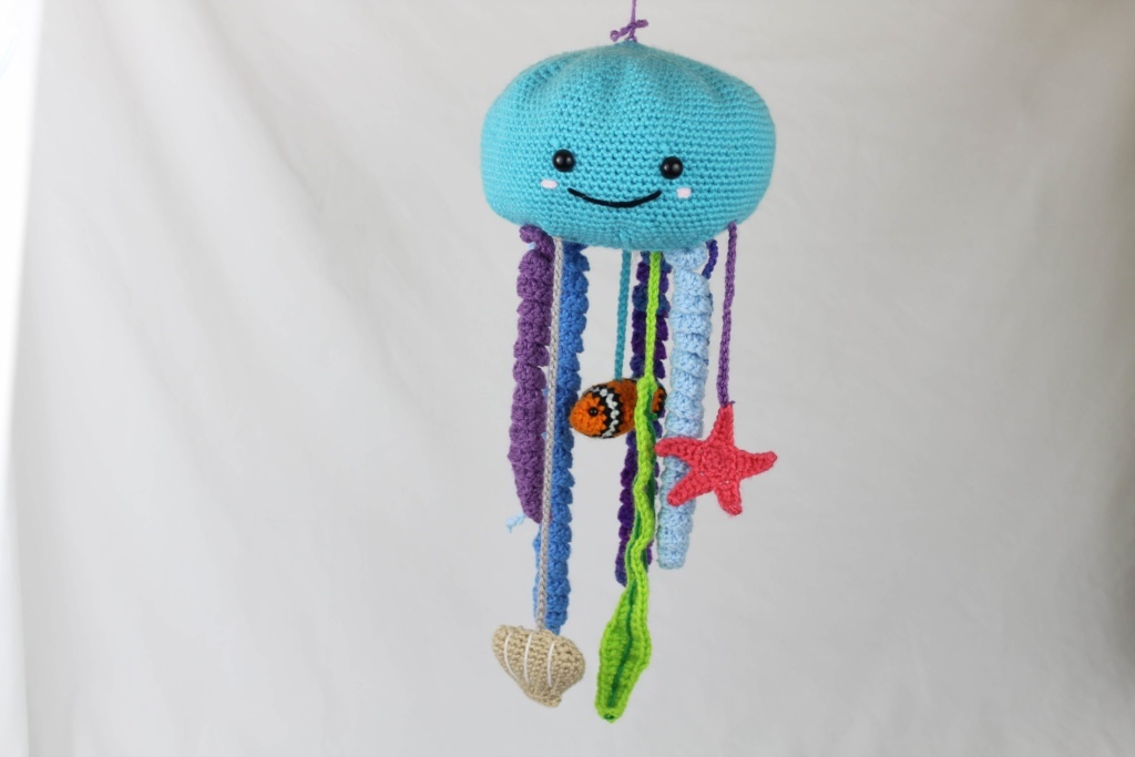 Blue crochet octopus baby mobile with hanging sea-life motifs